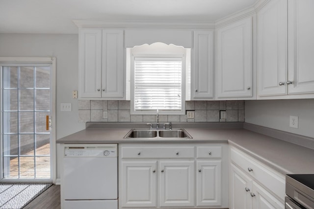 kitchen featuring tasteful backsplash, sink, white cabinets, and white dishwasher