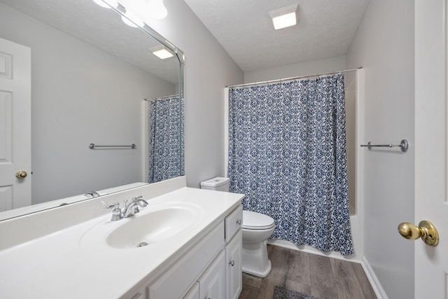 full bathroom featuring toilet, a textured ceiling, vanity, shower / bathtub combination with curtain, and hardwood / wood-style flooring