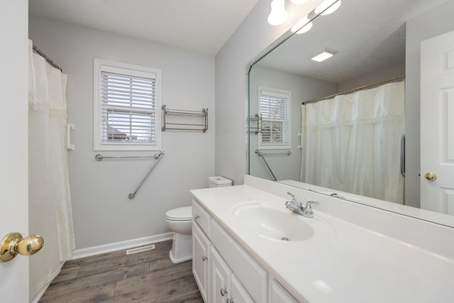 bathroom with vanity, hardwood / wood-style floors, and toilet