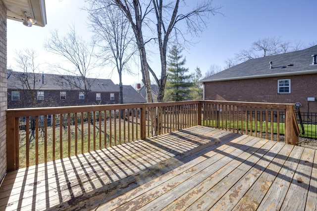 wooden terrace with a lawn