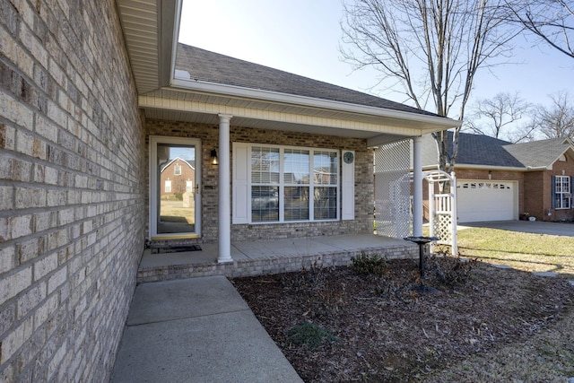 entrance to property with a garage and a porch