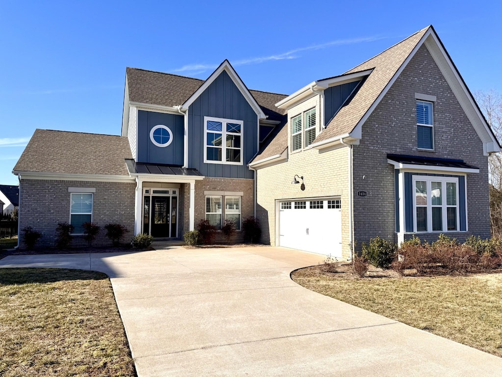 view of front of home featuring a garage and a front yard