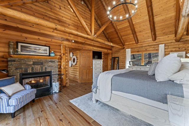 bedroom featuring high vaulted ceiling, light hardwood / wood-style flooring, log walls, beamed ceiling, and a fireplace