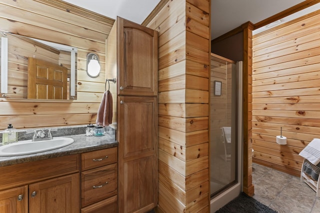 bathroom featuring an enclosed shower, vanity, and wood walls