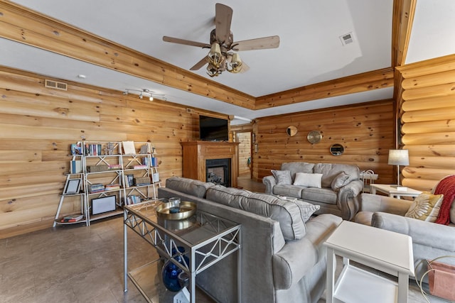 living room featuring log walls and ceiling fan