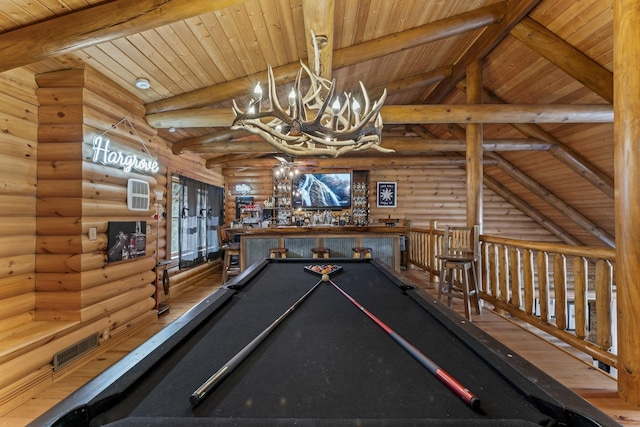 game room with a notable chandelier, wood ceiling, log walls, and lofted ceiling with beams