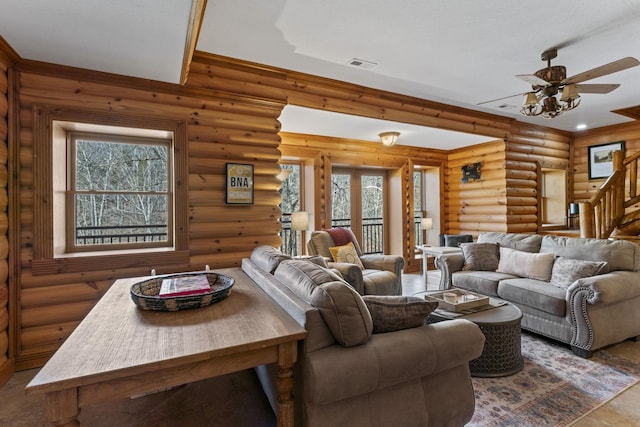 living room featuring ceiling fan and rustic walls