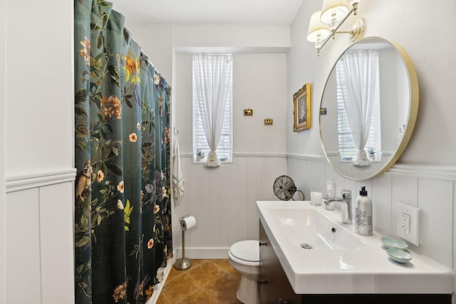 bathroom featuring vanity, tile patterned floors, and toilet