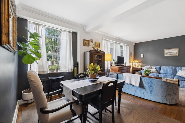 dining space featuring beamed ceiling and hardwood / wood-style flooring