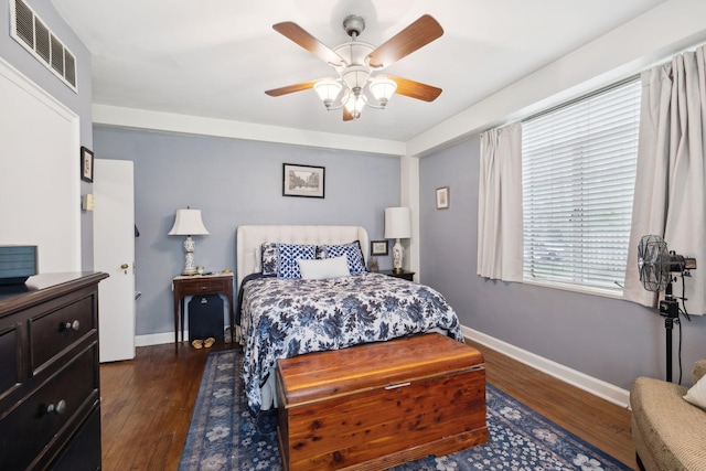 bedroom with dark hardwood / wood-style floors and ceiling fan