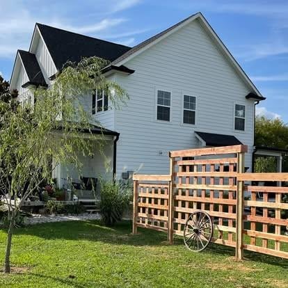 rear view of house with a yard