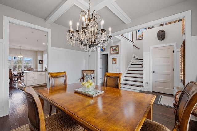 dining area featuring beam ceiling, dark wood-type flooring, and a chandelier