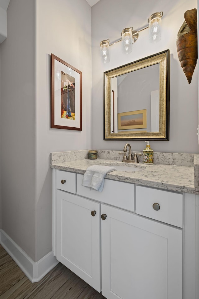 bathroom with vanity and hardwood / wood-style floors