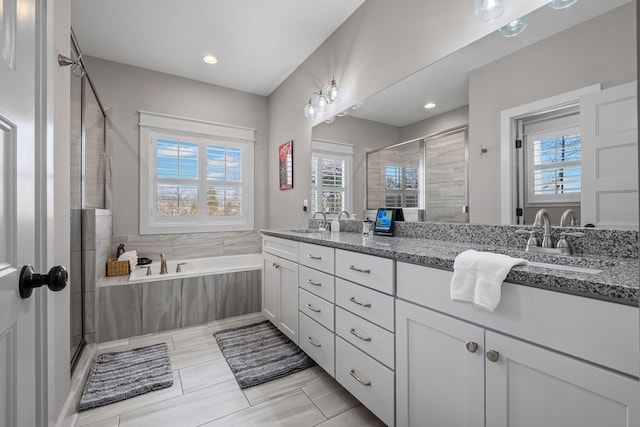 bathroom featuring vanity, tile patterned floors, and shower with separate bathtub