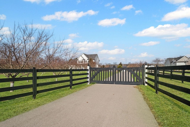 view of gate featuring a yard