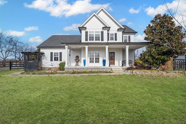 view of front of property with covered porch and a front lawn