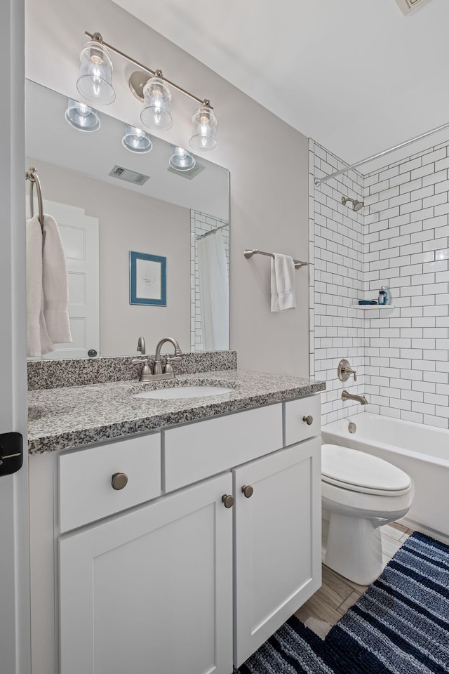 full bathroom with vanity, hardwood / wood-style flooring, toilet, and shower / bath combo with shower curtain