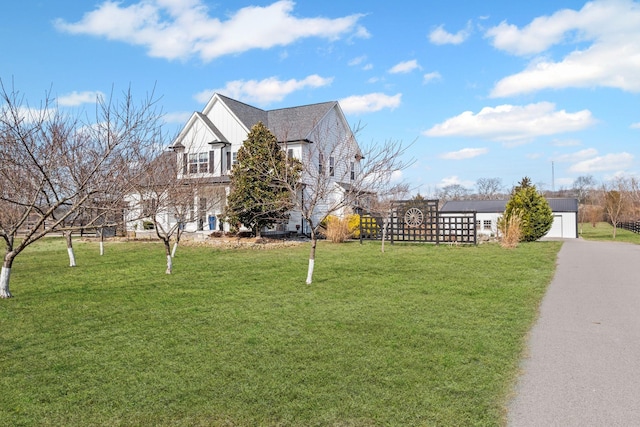 view of home's exterior with a garage and a lawn