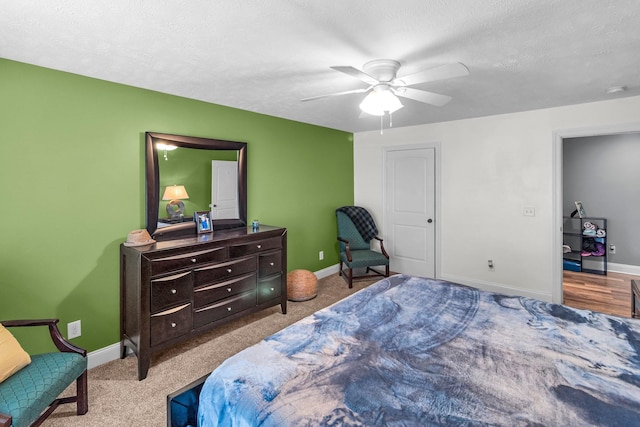 bedroom with light carpet, a textured ceiling, and ceiling fan