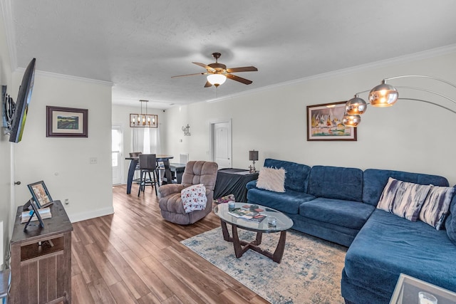 living room with hardwood / wood-style flooring, crown molding, ceiling fan, and a textured ceiling