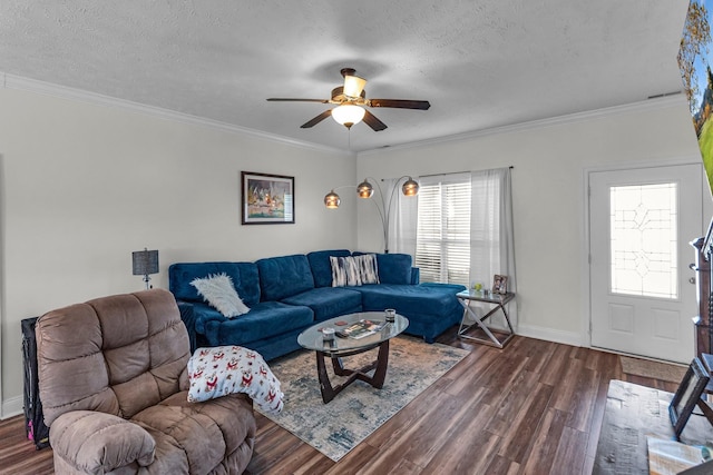 living room with crown molding, dark hardwood / wood-style flooring, ceiling fan, and a textured ceiling