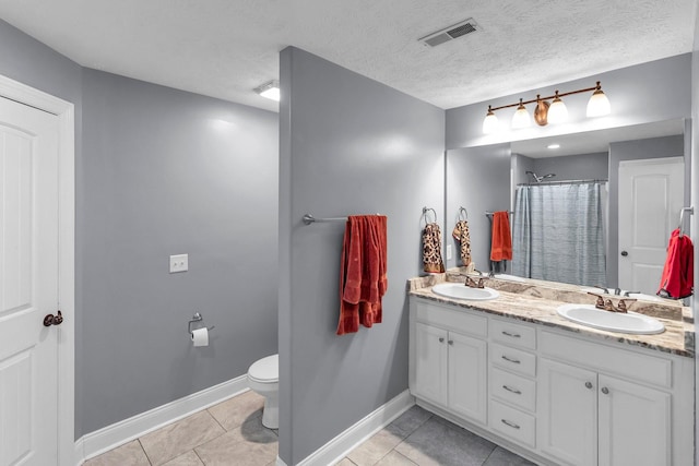 bathroom with tile patterned flooring, a shower with shower curtain, vanity, a textured ceiling, and toilet