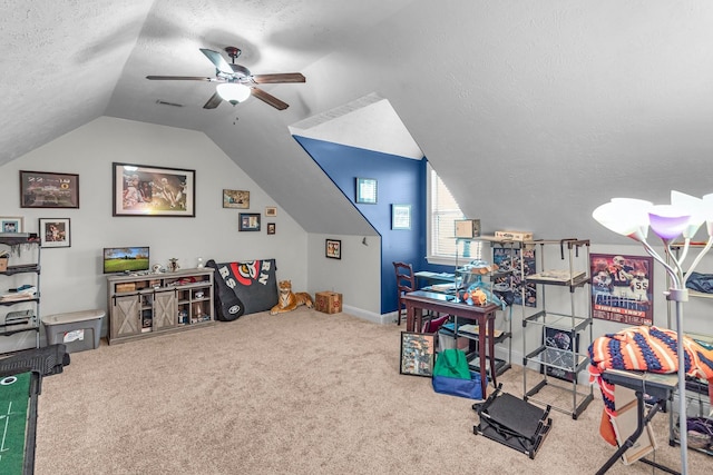 rec room with ceiling fan, lofted ceiling, carpet floors, and a textured ceiling