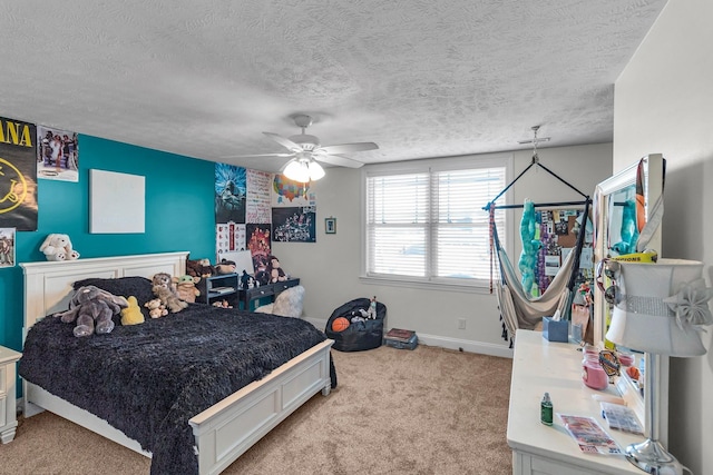 carpeted bedroom featuring a textured ceiling and ceiling fan