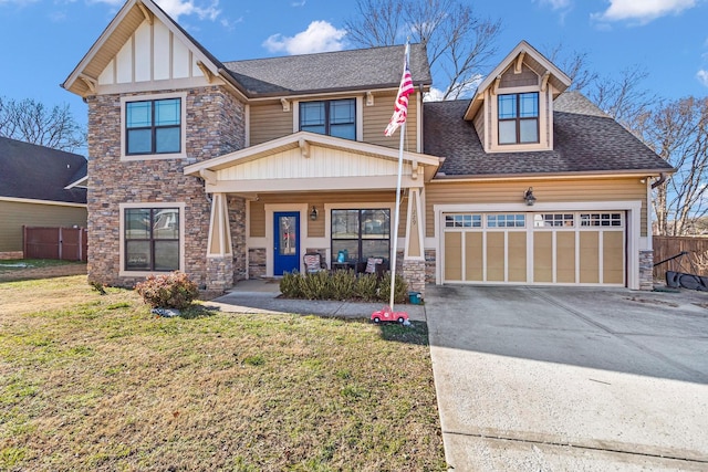 craftsman house with a garage, a front yard, and covered porch