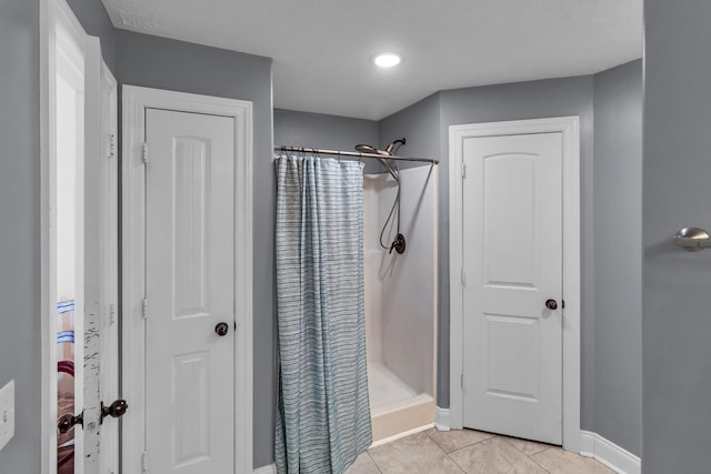 bathroom with tile patterned floors and curtained shower