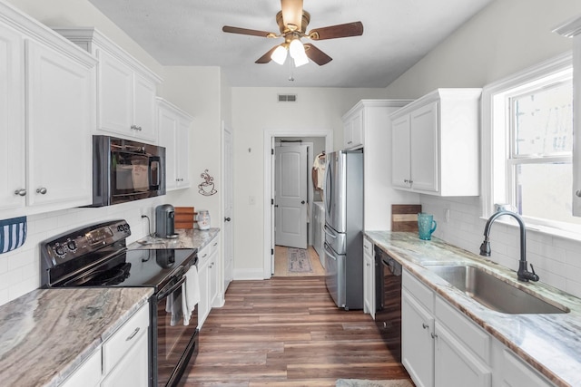 kitchen with sink, decorative backsplash, black appliances, and white cabinets