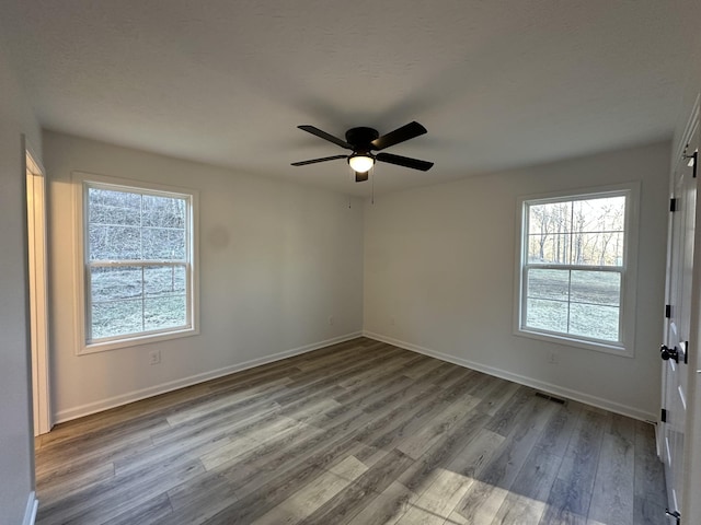 empty room with ceiling fan and light wood-type flooring