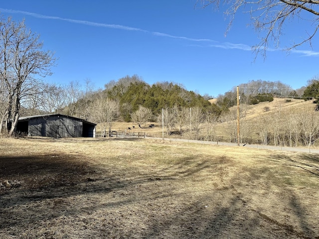 view of yard with a rural view and an outbuilding