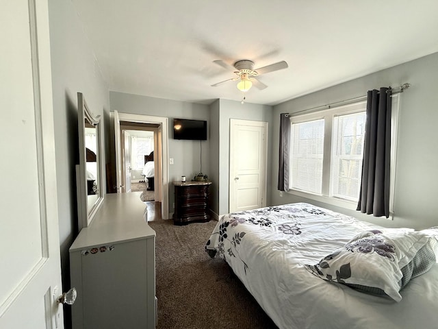 bedroom with ceiling fan and dark carpet