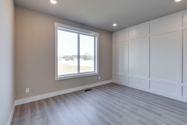 spare room with light hardwood / wood-style flooring