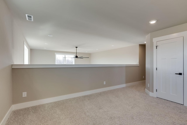 carpeted spare room featuring ceiling fan