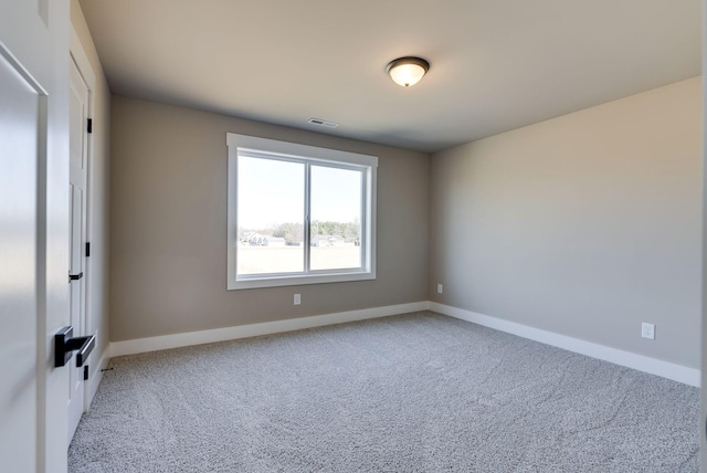 unfurnished room with light carpet