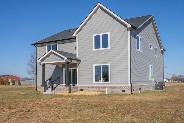 exterior space featuring central AC unit and a front yard