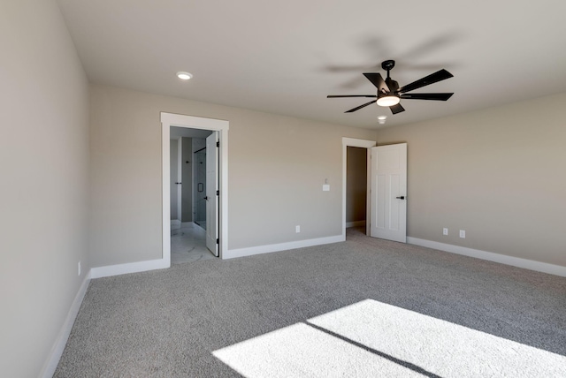 unfurnished bedroom with ceiling fan, ensuite bathroom, and light colored carpet