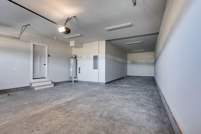 garage with a garage door opener, electric panel, and water heater