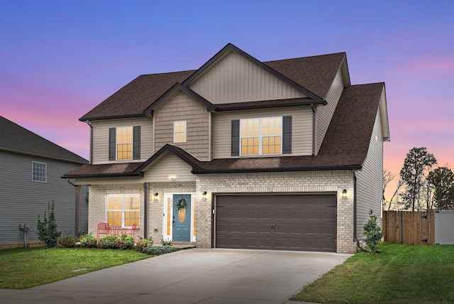 view of front of home featuring a garage and a lawn