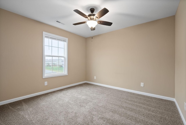 carpeted spare room with ceiling fan