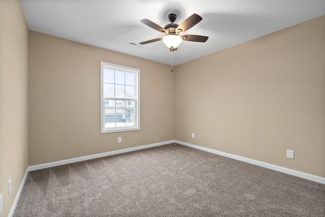 spare room with ceiling fan and carpet floors