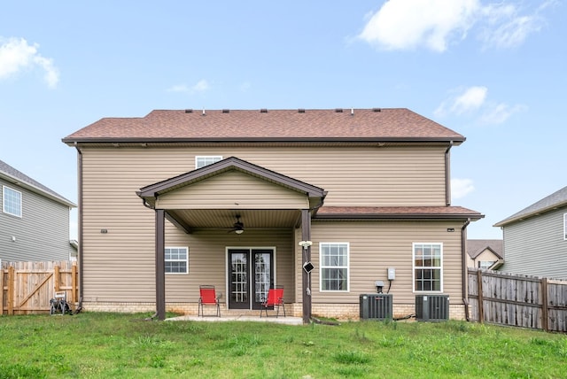 back of property featuring cooling unit, a yard, a patio area, and ceiling fan