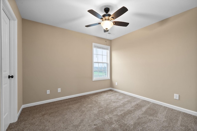 empty room with ceiling fan and carpet