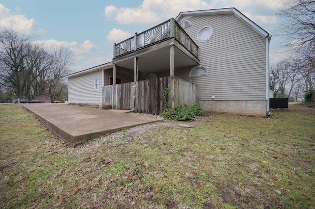 back of house featuring a patio and a yard