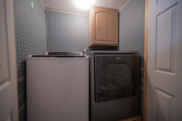 laundry area with washer and dryer, crown molding, cabinets, and a textured ceiling