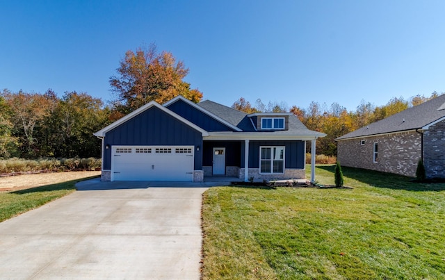 view of front of home with a porch, a garage, and a front yard