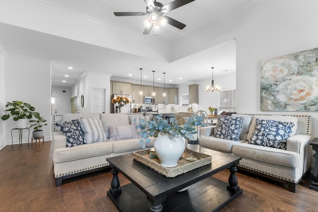 living room with ceiling fan with notable chandelier, dark wood-type flooring, and ornamental molding