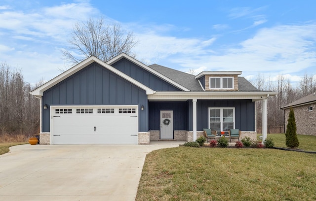 view of front of house with a garage, a front lawn, and a porch